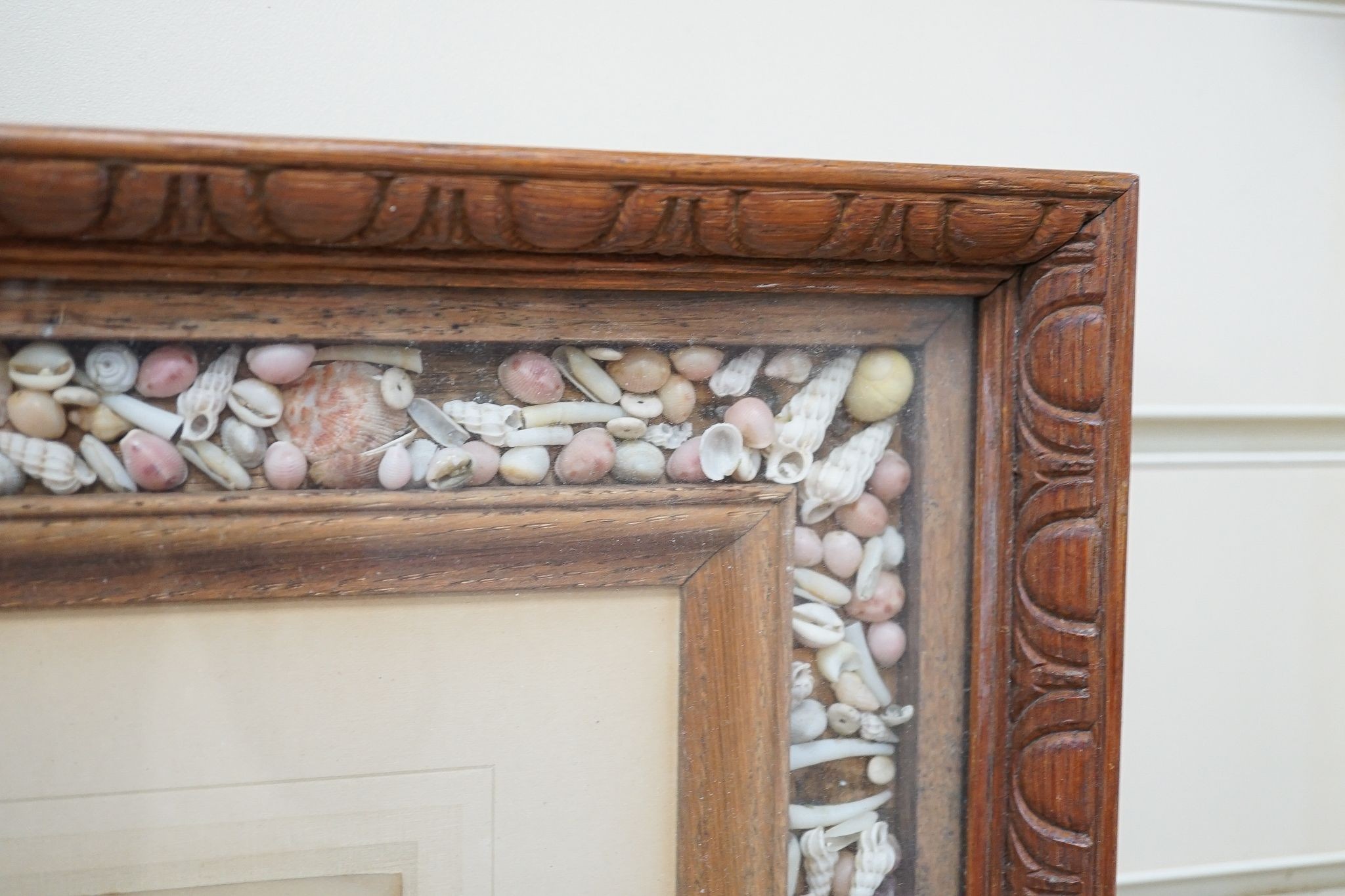 An oak and coloured shell picture frame, 49 x 53cm.